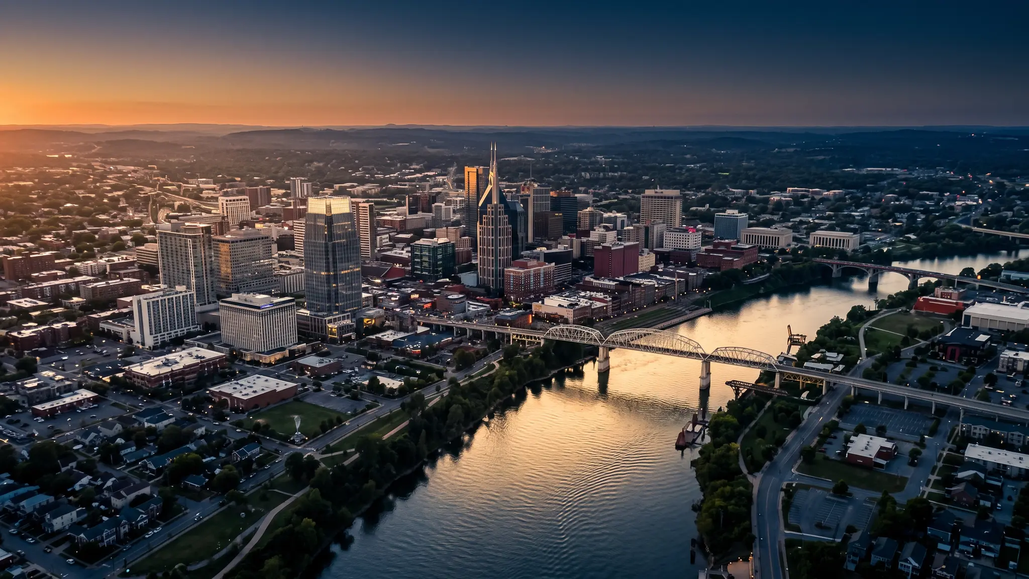 Aerial view of Nashville, Tennessee at sunset with the Cumberland River, the skyline and neighborhoods in golden light